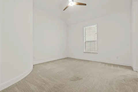 an empty room with a empty space and a ceiling fan