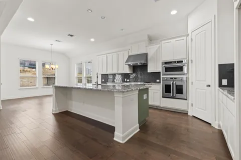 a kitchen with stainless steel appliances a refrigerator sink and microwave