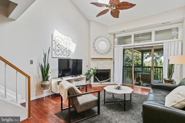 a living room with furniture a fireplace and a large window