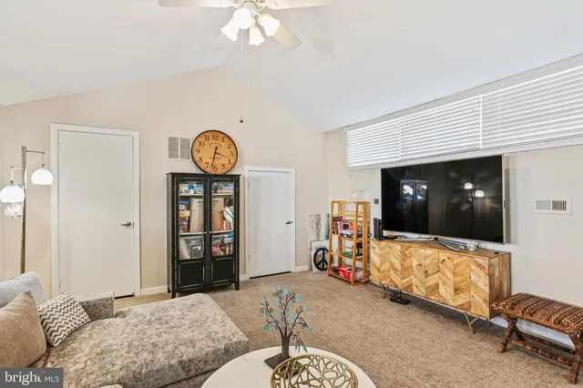 a bedroom with a bed and a view of living room