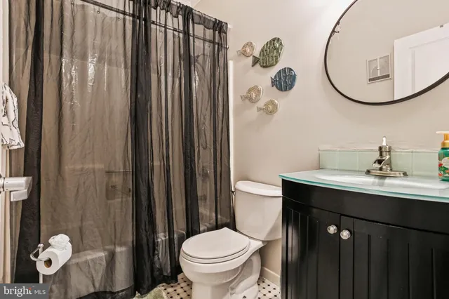 a bathroom with a sink a toilet and a mirror