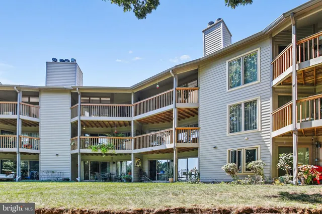 a front view of a building with a garden