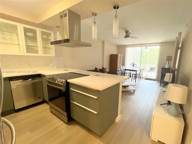 a kitchen with stainless steel appliances granite countertop a stove and a sink