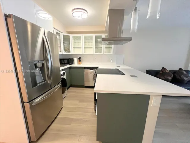 a kitchen that has a sink a refrigerator and window