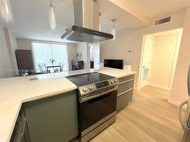 a kitchen with stainless steel appliances a stove a sink and a refrigerator