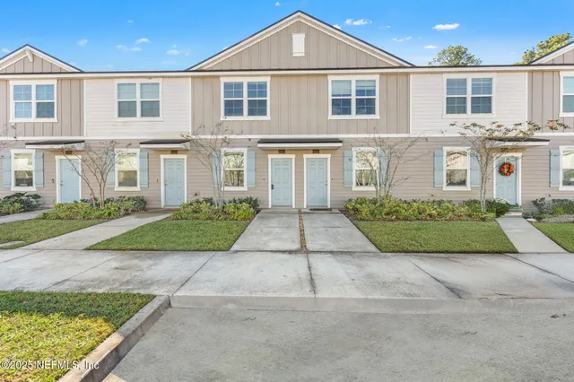 a front view of a house with a garden and yard