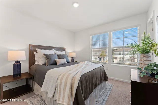 a bedroom with a bed and a large window