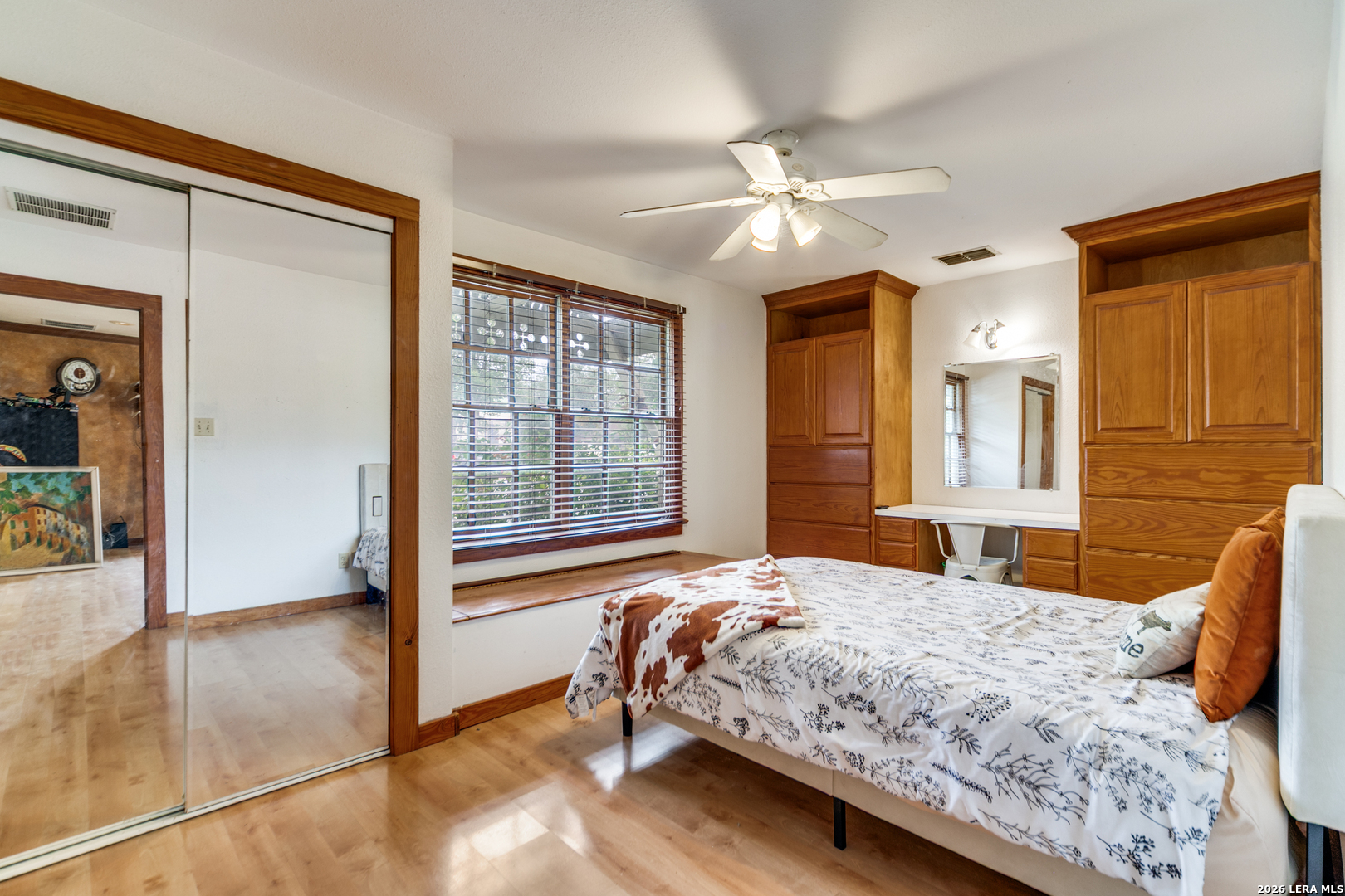 1201 Sisterdale Road Boerne, TX 78006 - Photo 8 of 17 a bedroom with a large bed and a chandelier