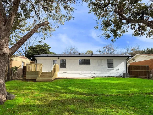 a view of a house with backyard sitting area and garden