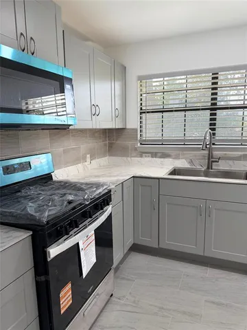 a kitchen with stainless steel appliances granite countertop a stove and a sink