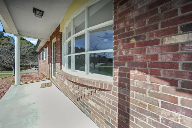 a view of a brick house with a large window