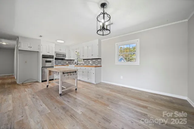 a view of kitchen with microwave and cabinets