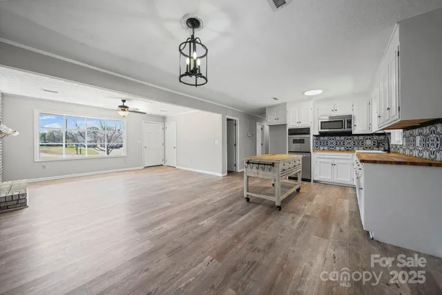 a living room with furniture and kitchen view