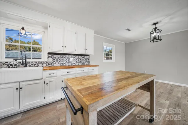 a kitchen with a stove and white cabinets