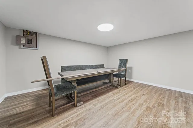 a reading room with wooden floor and furniture