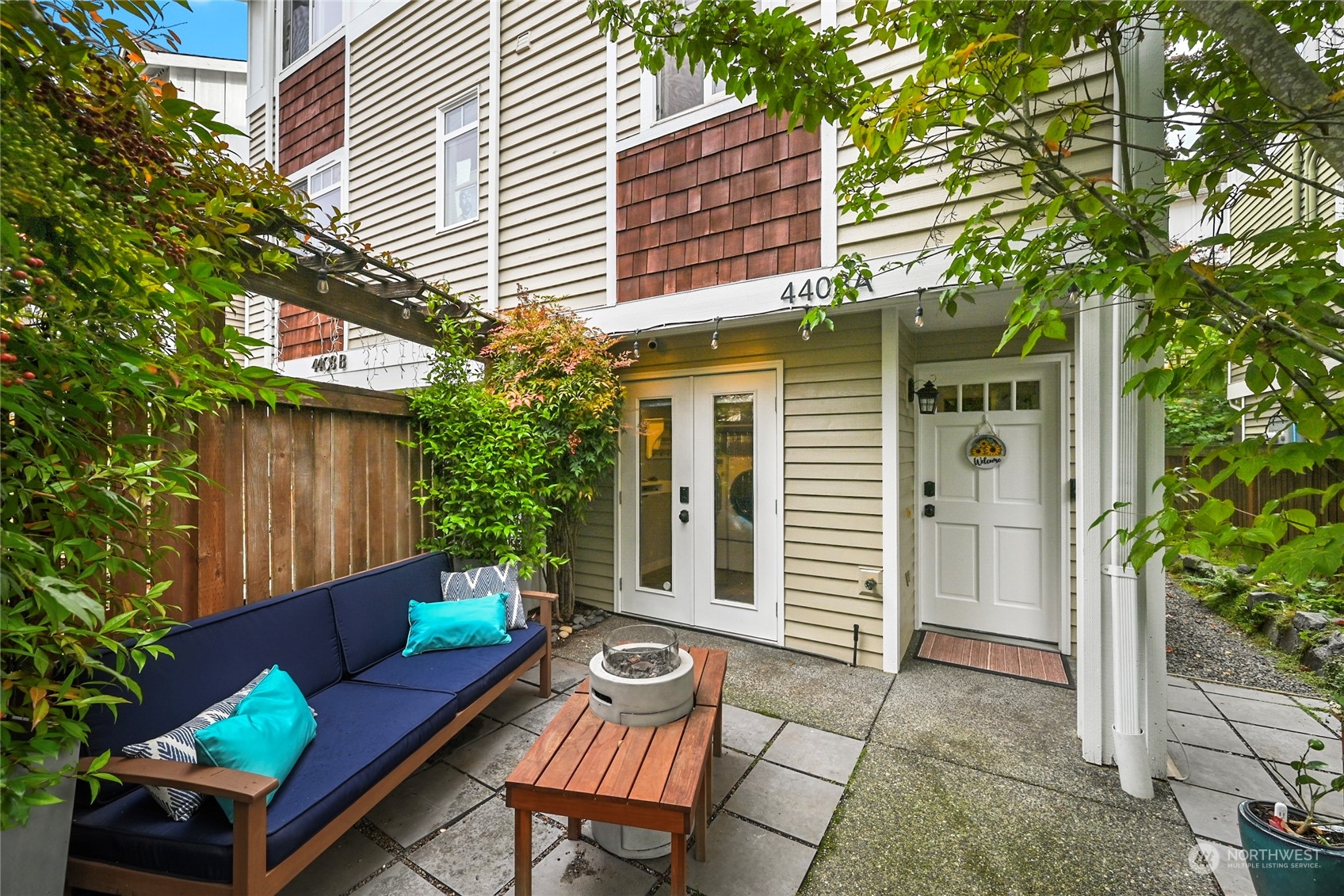 4408 Meridian Avenue North, Unit A Seattle, WA 98103 - Photo 1 of 31 a view of a house with a chairs in a patio
