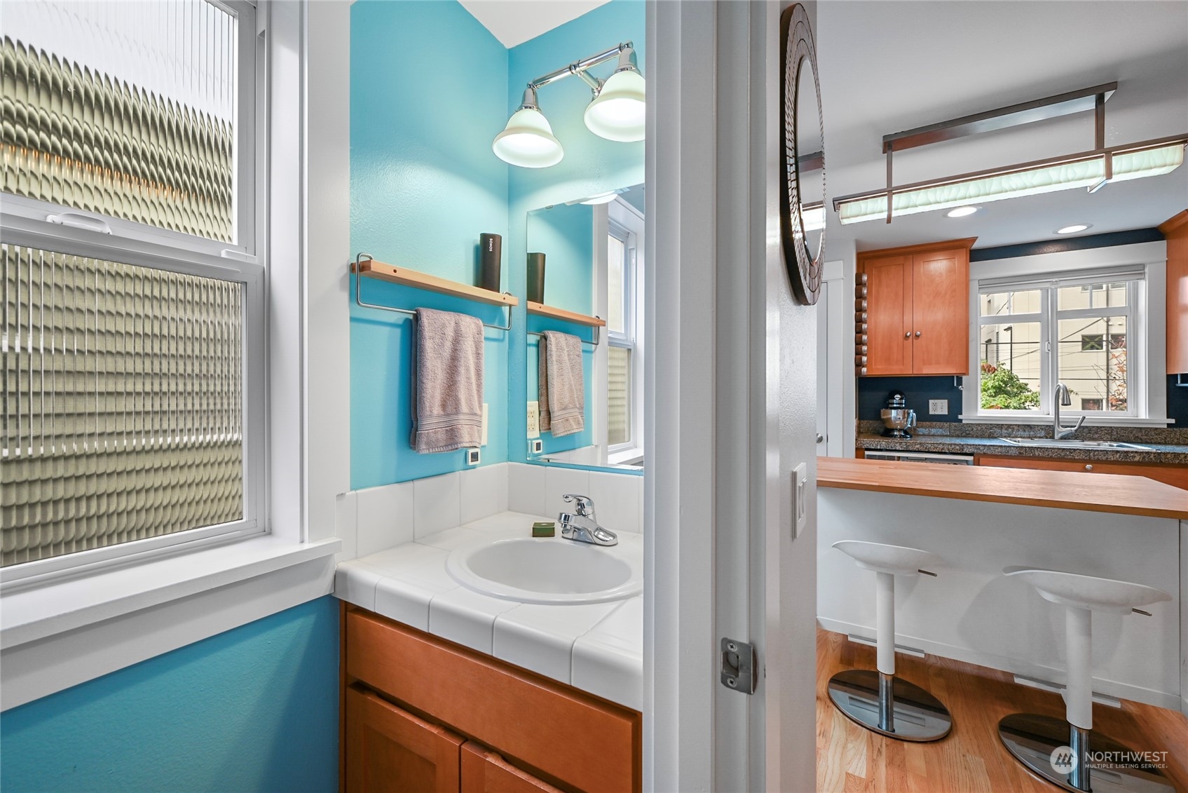 4408 Meridian Avenue North, Unit A Seattle, WA 98103 - Photo 11 of 31 a bathroom with a sink and a mirror