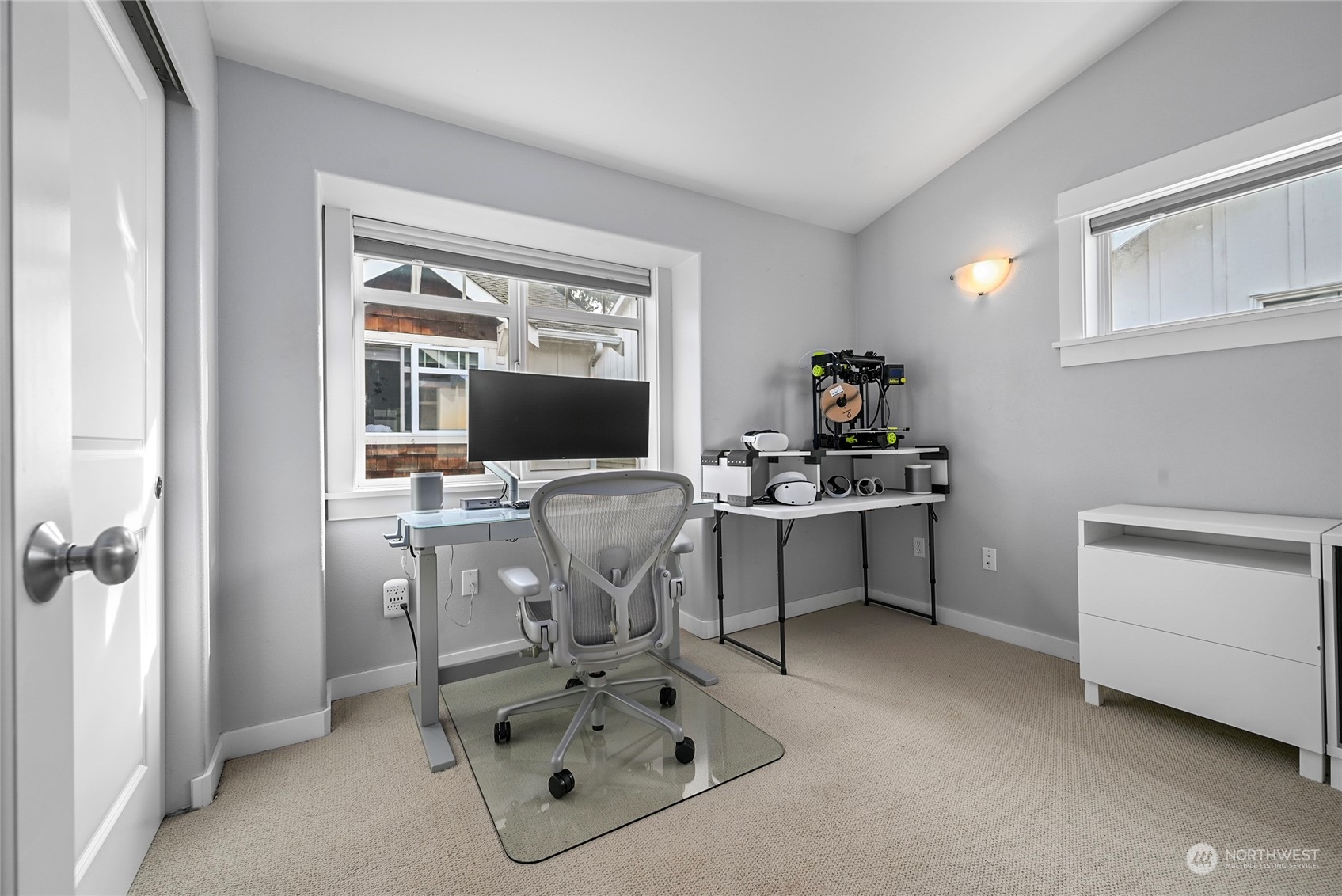 4408 Meridian Avenue North, Unit A Seattle, WA 98103 - Photo 13 of 31 a work room with furniture a flat screen tv and a window