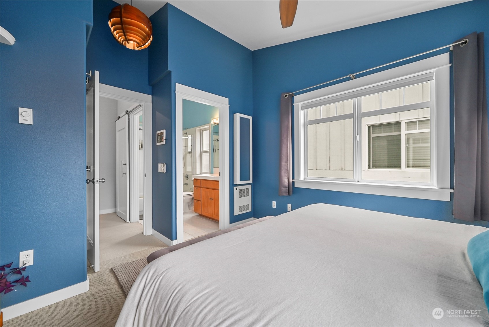4408 Meridian Avenue North, Unit A Seattle, WA 98103 - Photo 18 of 31 a bedroom with a bed and a window