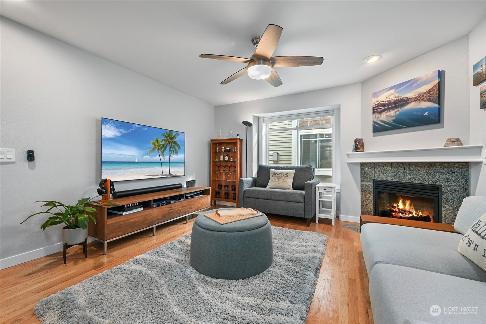4408 Meridian Avenue North, Unit A Seattle, WA 98103 - Photo 2 of 31 a living room with furniture a flat screen tv and a fireplace