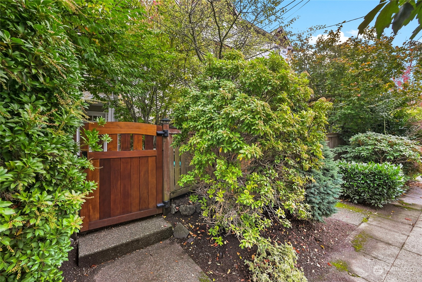 4408 Meridian Avenue North, Unit A Seattle, WA 98103 - Photo 28 of 31 a view of a wooden fence with a tree