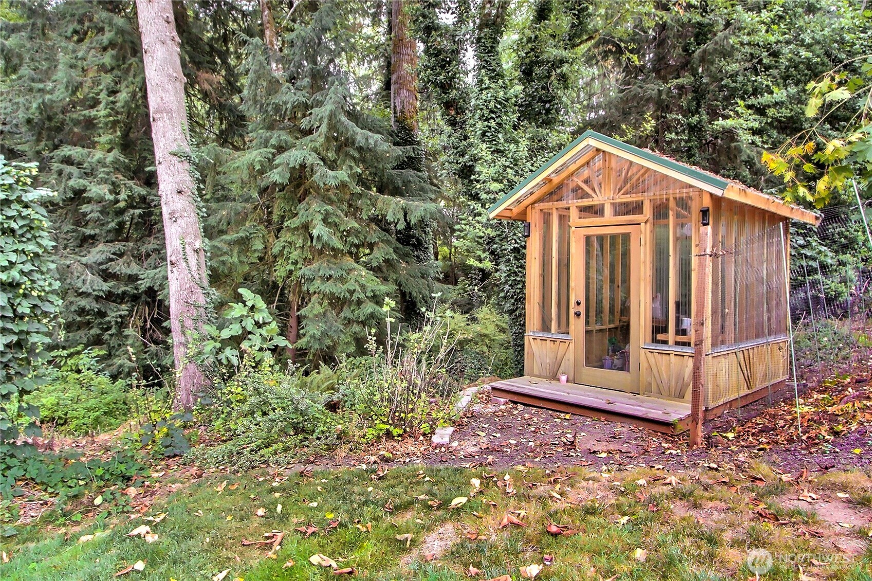 3841 Mari Lane Southeast Olympia, WA 98513 - Photo 21 of 24 a view of a wooden house with a small yard and large tree