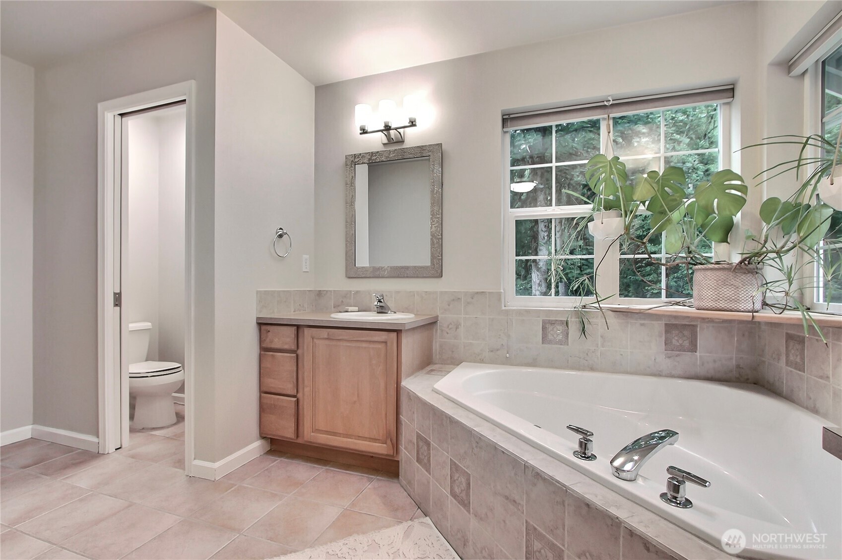 3841 Mari Lane Southeast Olympia, WA 98513 - Photo 10 of 24 a bathroom with a tub a sink and a window