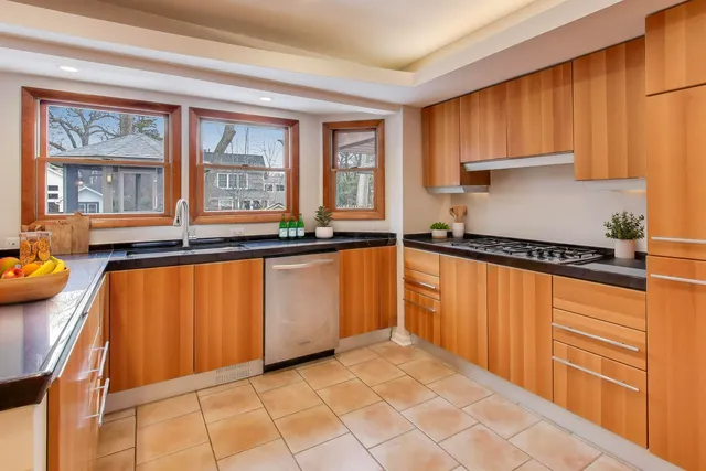 a kitchen with stainless steel appliances granite countertop a refrigerator and a sink
