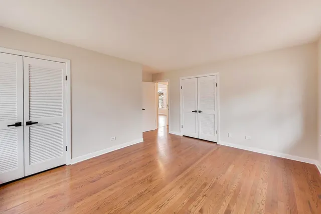 a bathroom with a toilet a sink a mirror and a shower