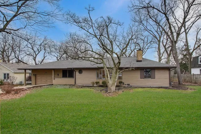 a house view with a sitting space and garden