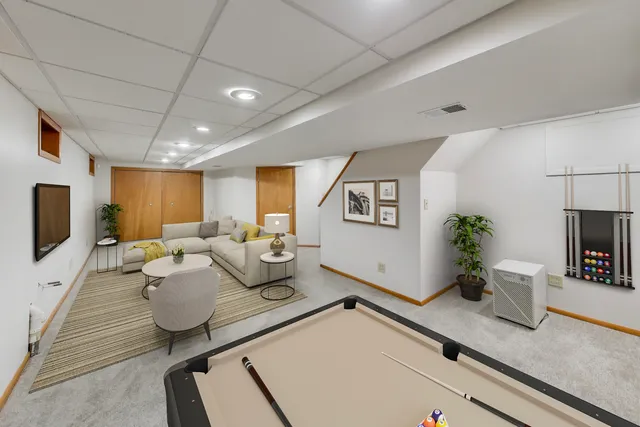 a front view of a house with yard and trees