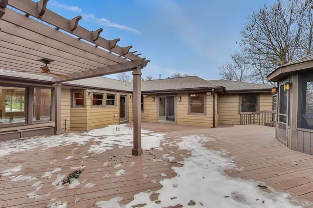 a view of a house with backyard and sitting area