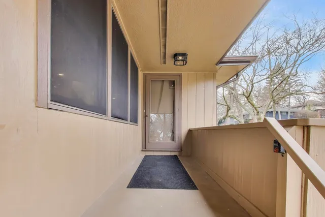 a living room with furniture floor to ceiling window and a flat screen tv