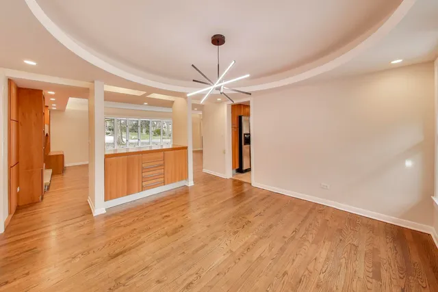 a kitchen with granite countertop a stove a sink and a refrigerator