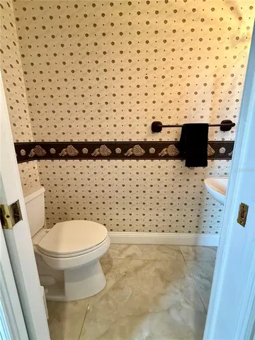 a view of a hallway with wooden floor and furniture