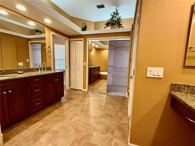 a view of a room with a ceiling fan and window