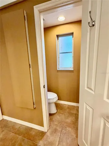 a view of a backyard with a patio and dining tub