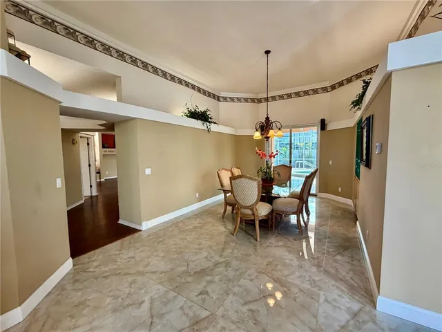an aerial view of residential houses with outdoor space and trees all around
