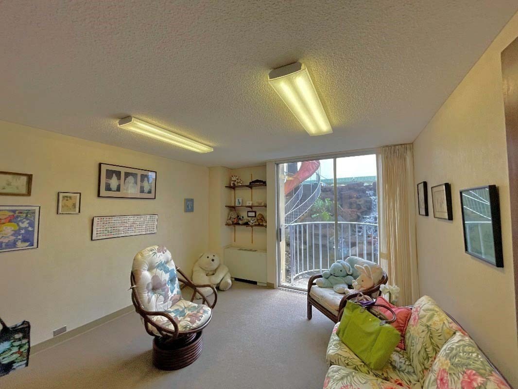 101 Aupuni Street, Unit 119 Hilo, HI 96720 - Photo 9 of 23 Open and inviting office area. Patio door opens up to the beautiful pond and waterfall.