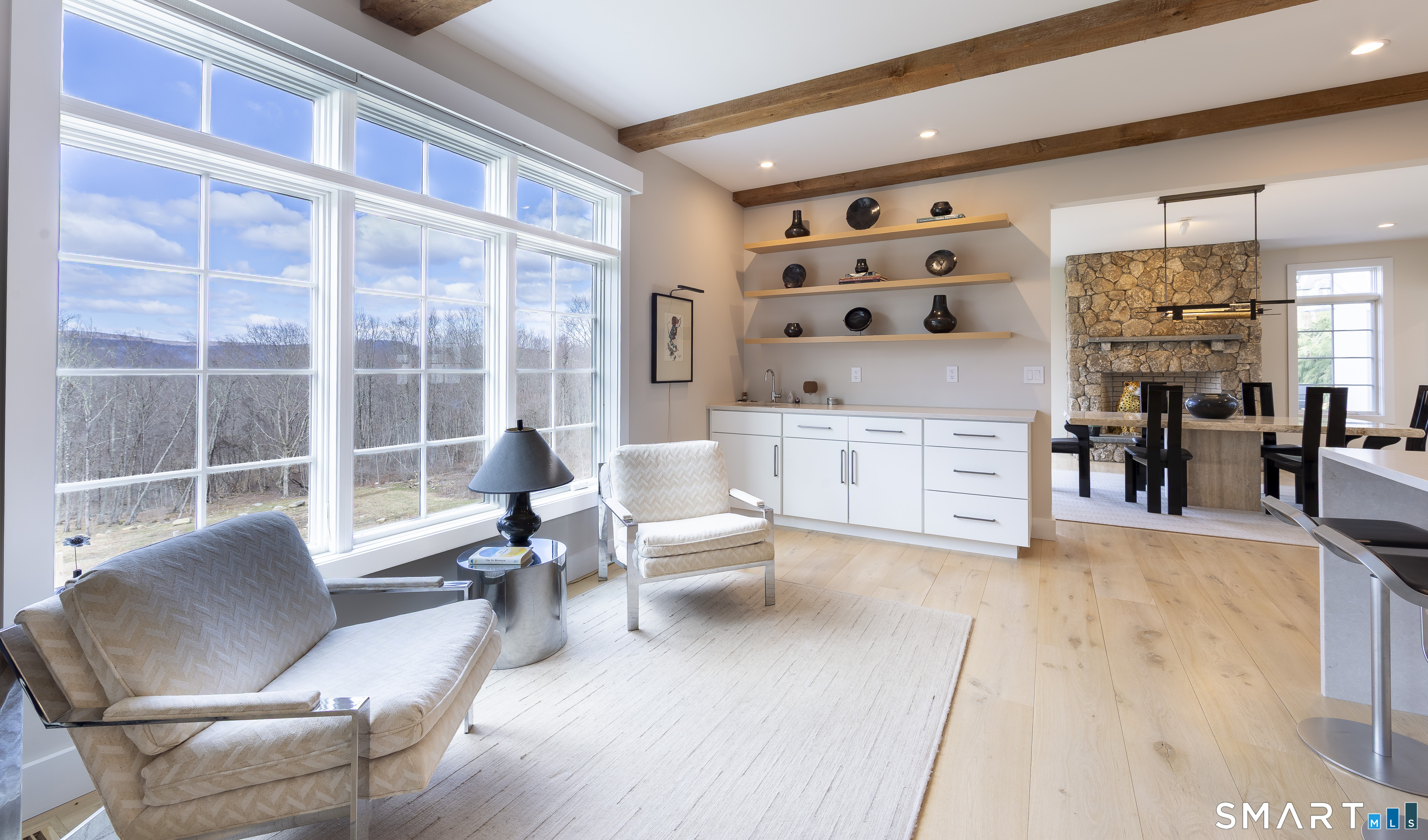 5 Upland Pastures Road Sherman, CT 06784 - Photo 16 of 40 Breakfast area with wet bar featuring custom cabinets, floating shelving, bar sink and quartz counters.