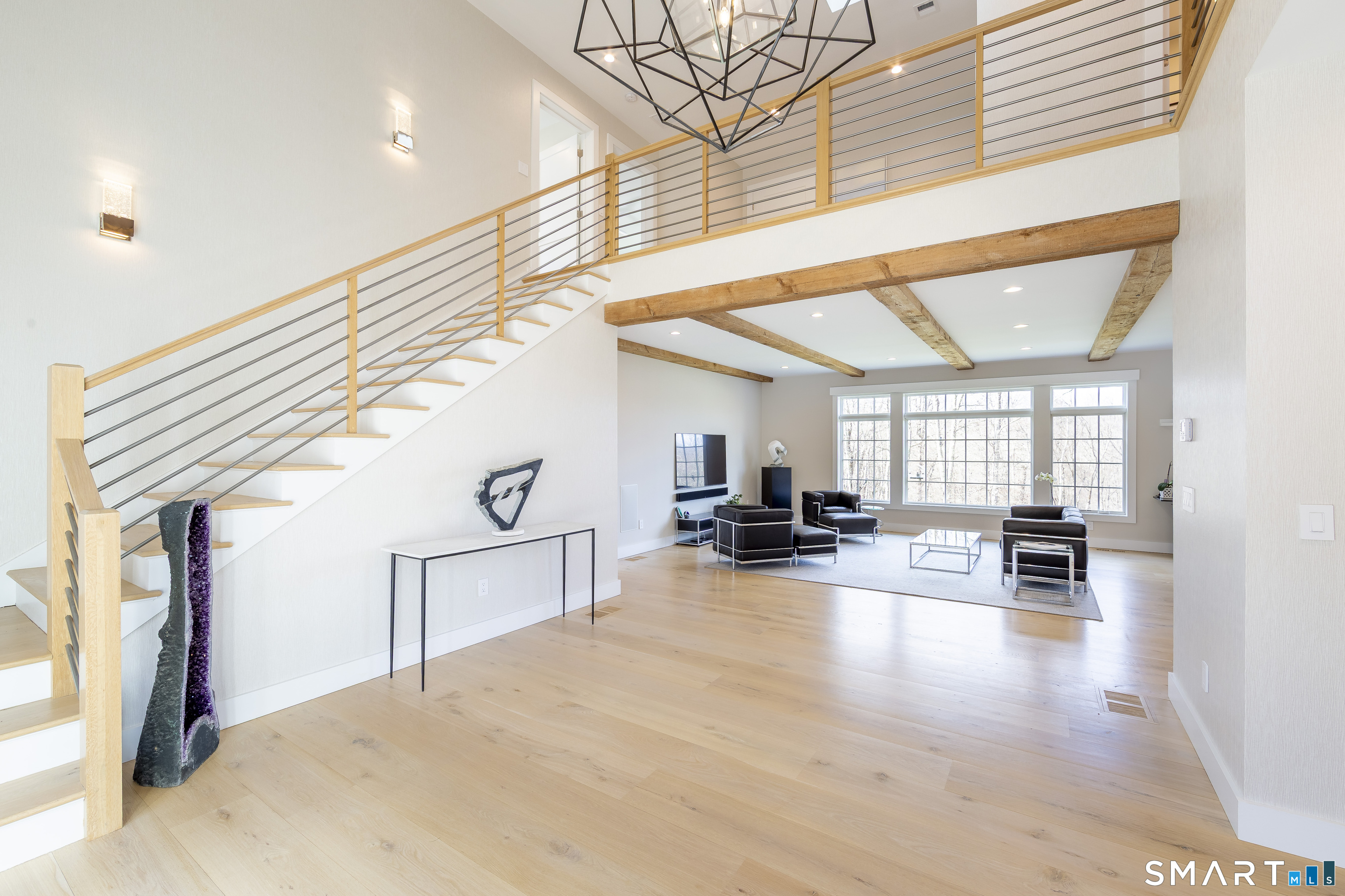 5 Upland Pastures Road Sherman, CT 06784 - Photo 9 of 40 Showcasing a split staircase with sleek stainless-steel cabling and an open balcony above.