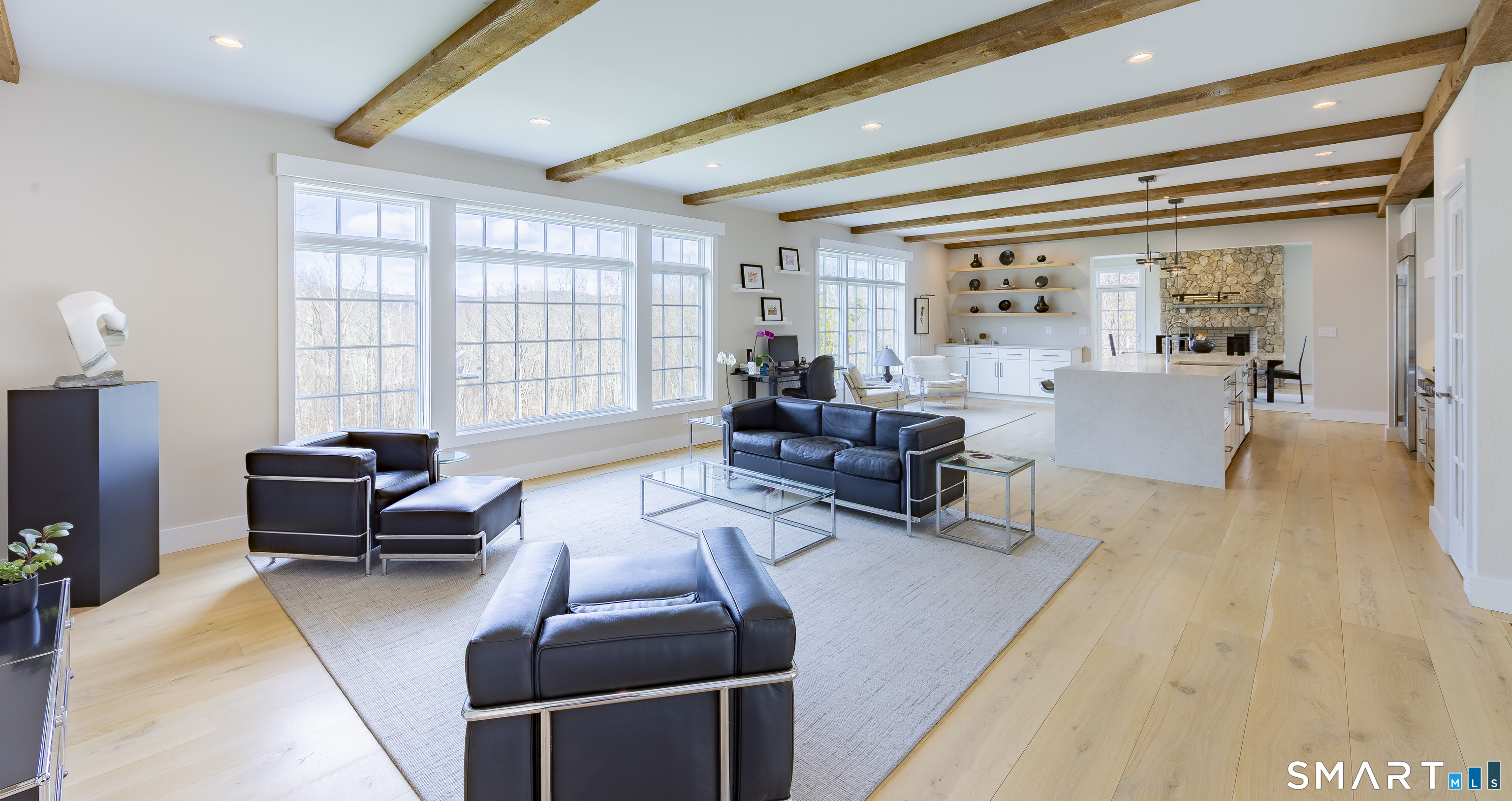 5 Upland Pastures Road Sherman, CT 06784 - Photo 10 of 40 The main level is defined by soaring 9-foot ceilings, reclaimed wood beams, wide-plank white oak floors, and expansive windows and doors that invite natural light into every corner.