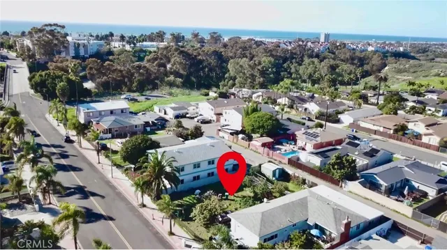 a view of a house with backyard sitting area and garden