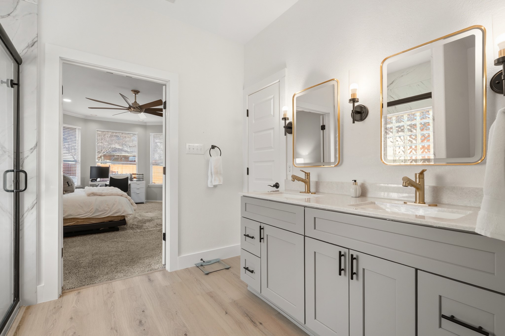 13922 Jubilee Way Helotes, TX 78023 - Photo 11 of 27 Full bathroom featuring double vanity, a marble finish shower, light wood-style flooring, and private water closet