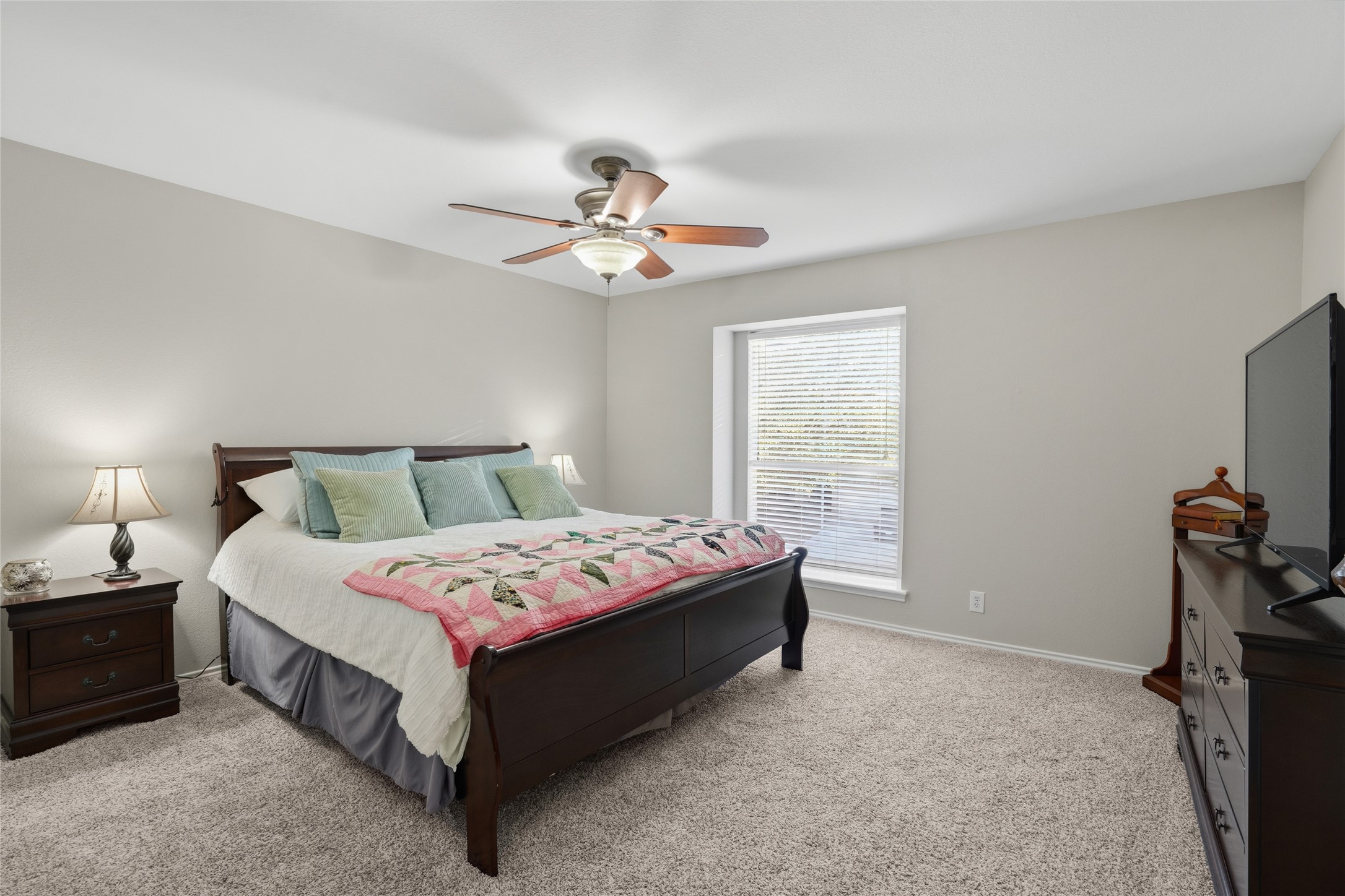 13922 Jubilee Way Helotes, TX 78023 - Photo 13 of 27 Bedroom featuring light carpet and a ceiling fan