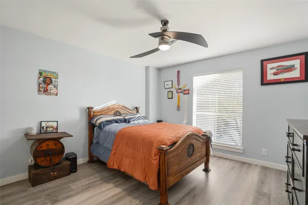 a bedroom with a bed and wooden floor