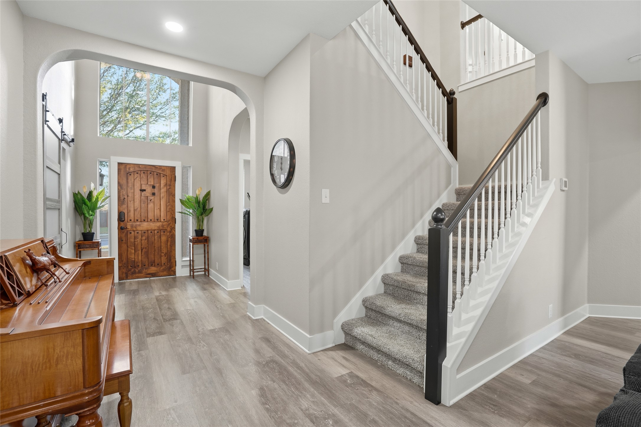 13922 Jubilee Way Helotes, TX 78023 - Photo 3 of 27 Foyer featuring arched walkways, a high ceiling, and light wood finished floors