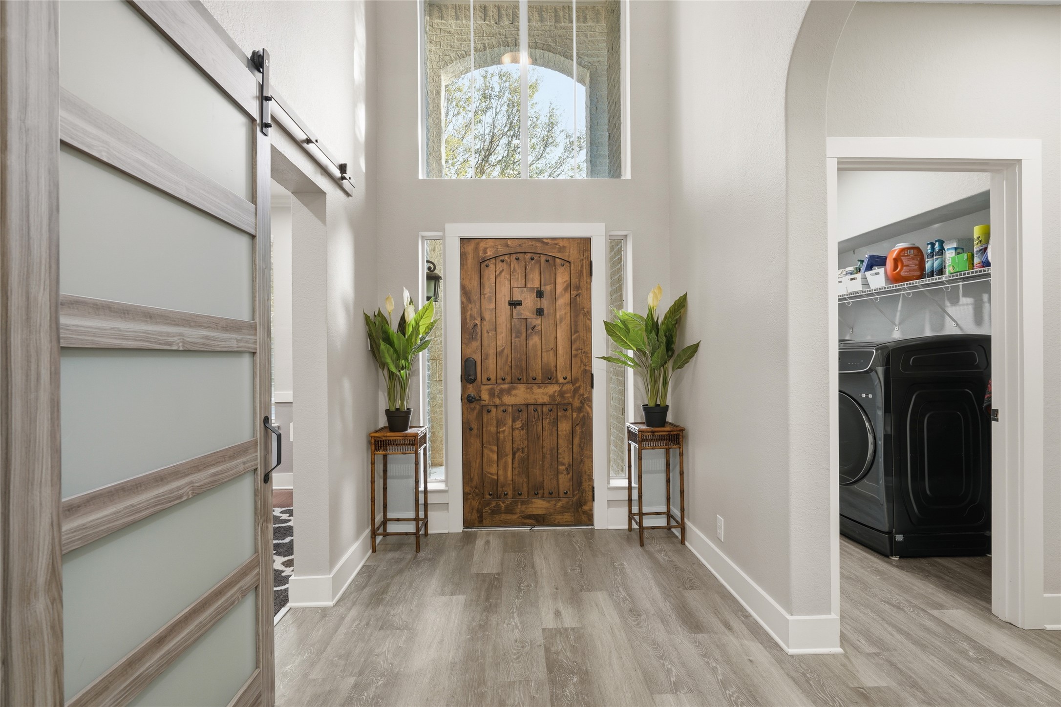 13922 Jubilee Way Helotes, TX 78023 - Photo 4 of 27 Foyer with a high ceiling, light wood-style floors, and arched walkways