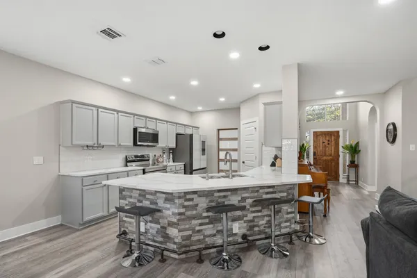 a kitchen with a sink stove and microwave