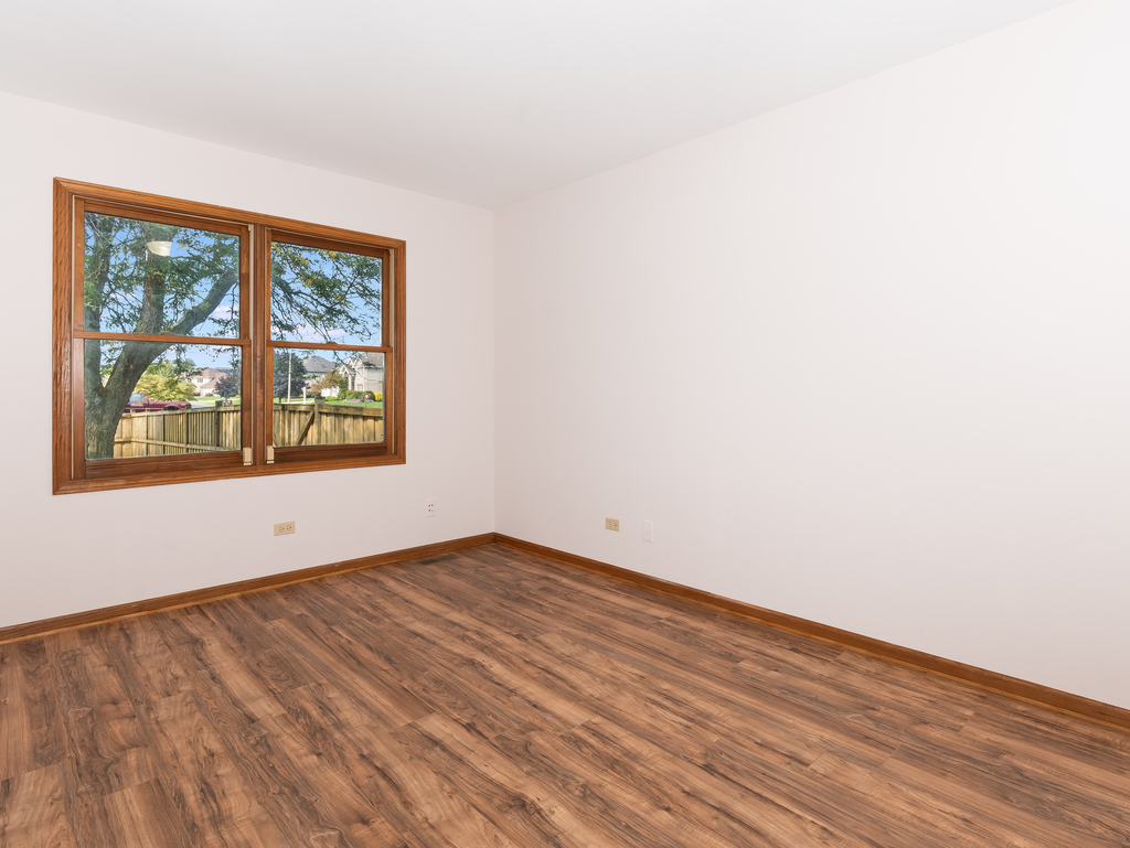 21322 Georgetown Road Frankfort, IL 60423 - Photo 13 of 28 an empty room with wooden floor and windows